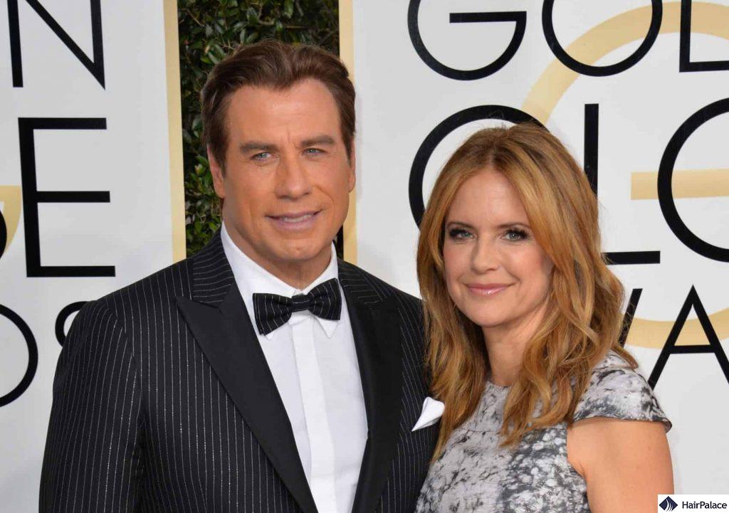 Travolta with a full head of hear appearing with wife Kelly Preston in early 2017